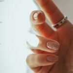 Hand with classic French tip nails