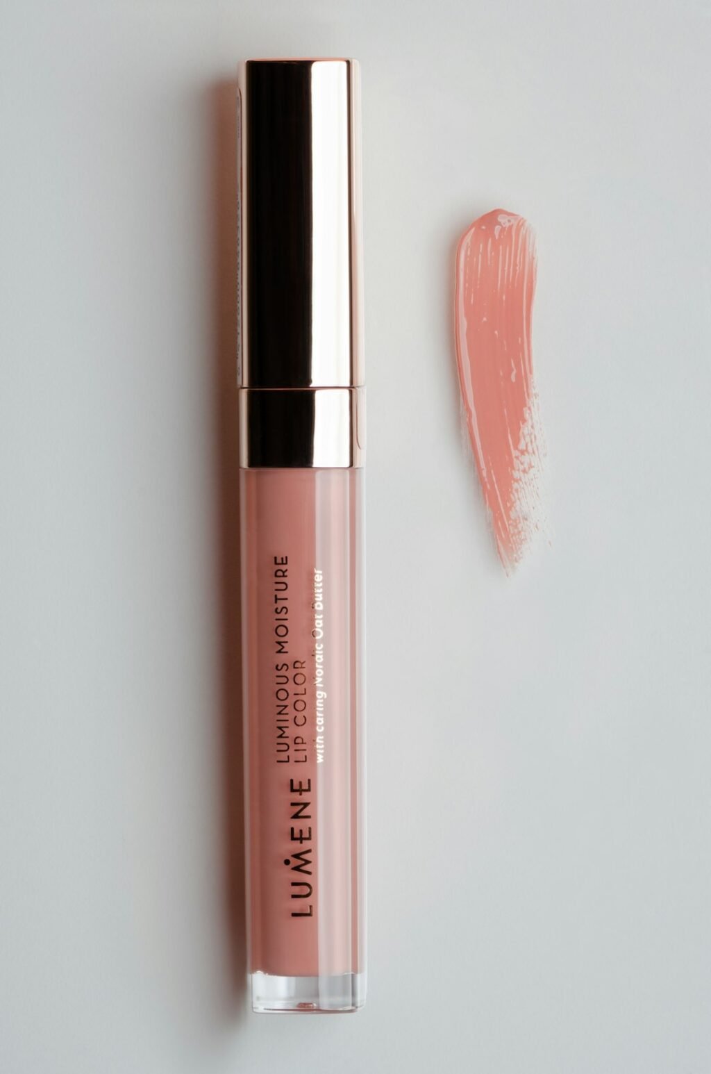Pink lip gloss next to a lipstick tube