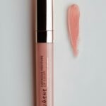 Pink lip gloss next to a lipstick tube